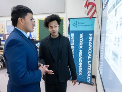 A teacher speaking with a student about financial literacy